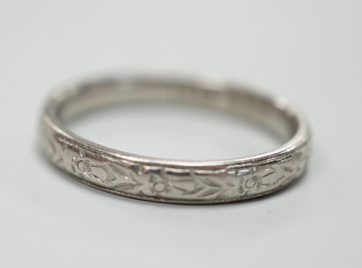 An engraved platinum wedding band, size M, 4.3 grams.